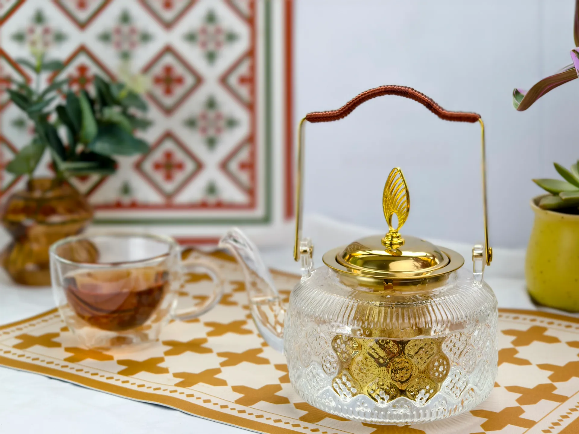 The 1L Floral-Embossed borosilicate Glass Teapot with golden infuser handle and lid